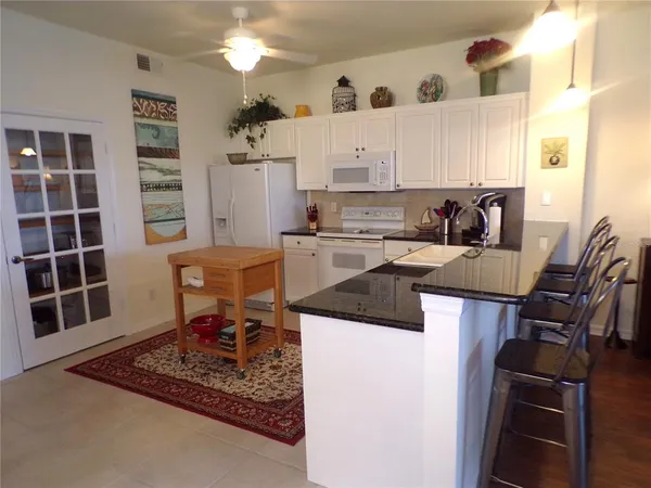 a kitchen with a sink cabinets and window