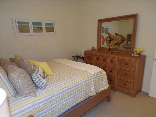 a bathroom with a granite countertop toilet sink and mirror