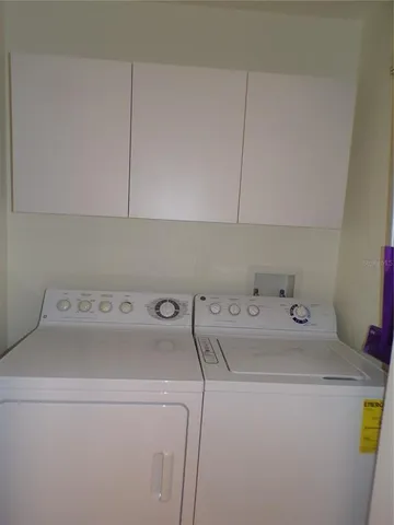 a view of a house with a window and wooden fence