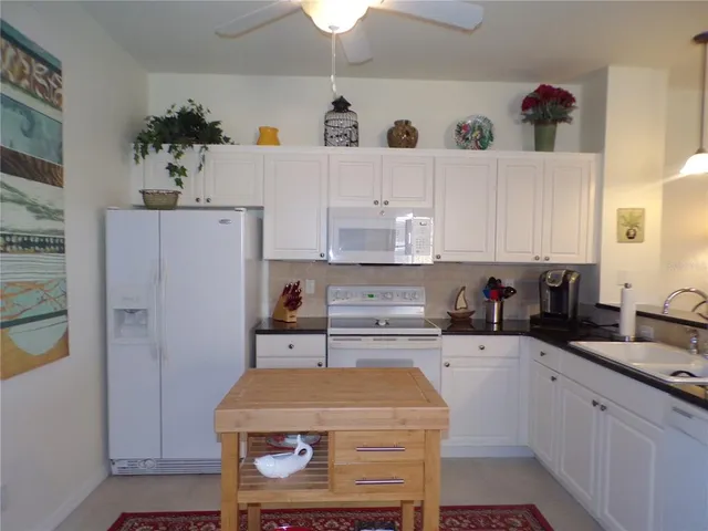 a living room with furniture a flat screen tv and a large window