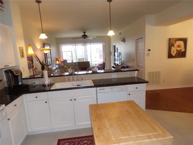 a view of a dining room with furniture wooden floor and chandelier