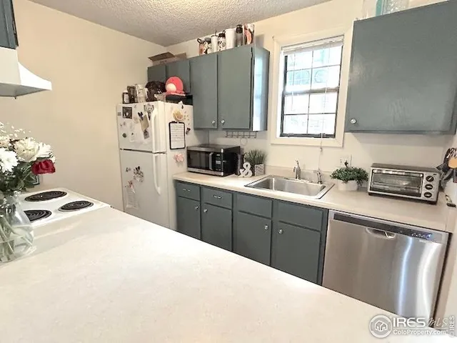 a kitchen with a sink stove and refrigerator