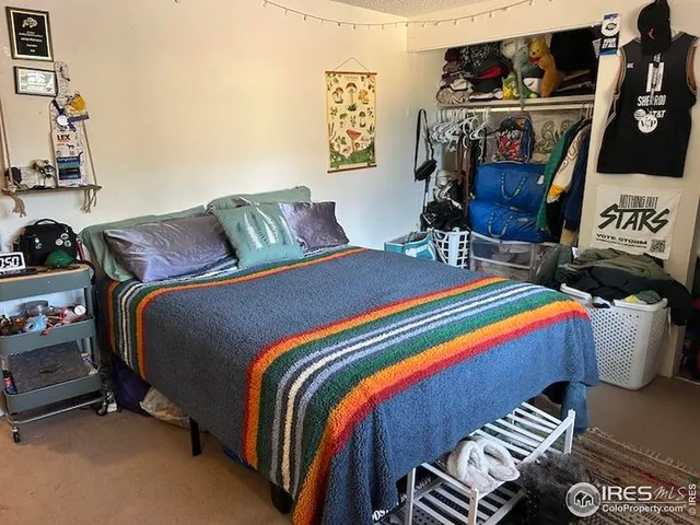 a bed room with a bed and a television