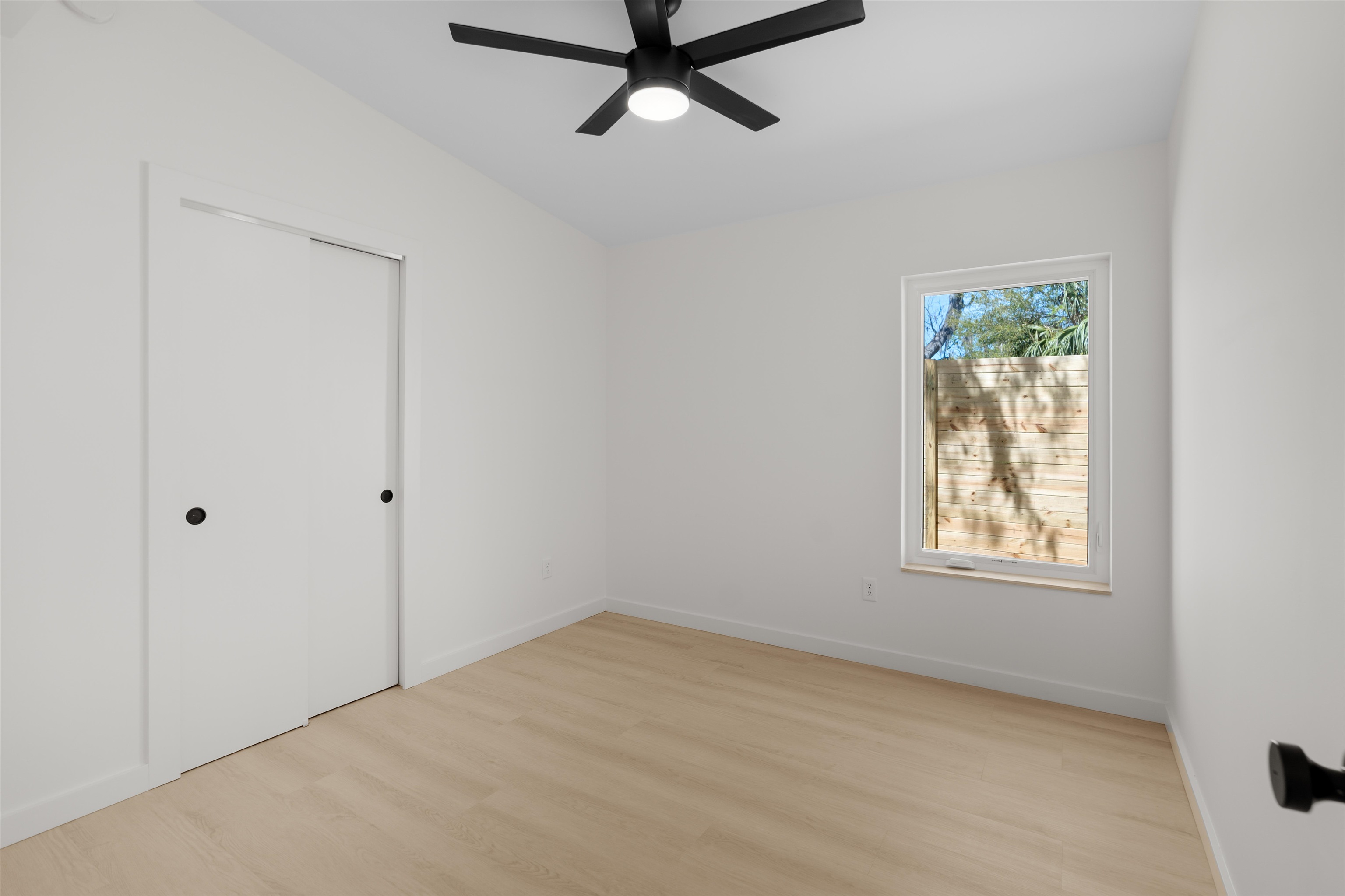 29 Masters Drive, Unit B St. Augustine, FL 32084 - Photo 12 of 28 an empty room with a window and a ceiling fan