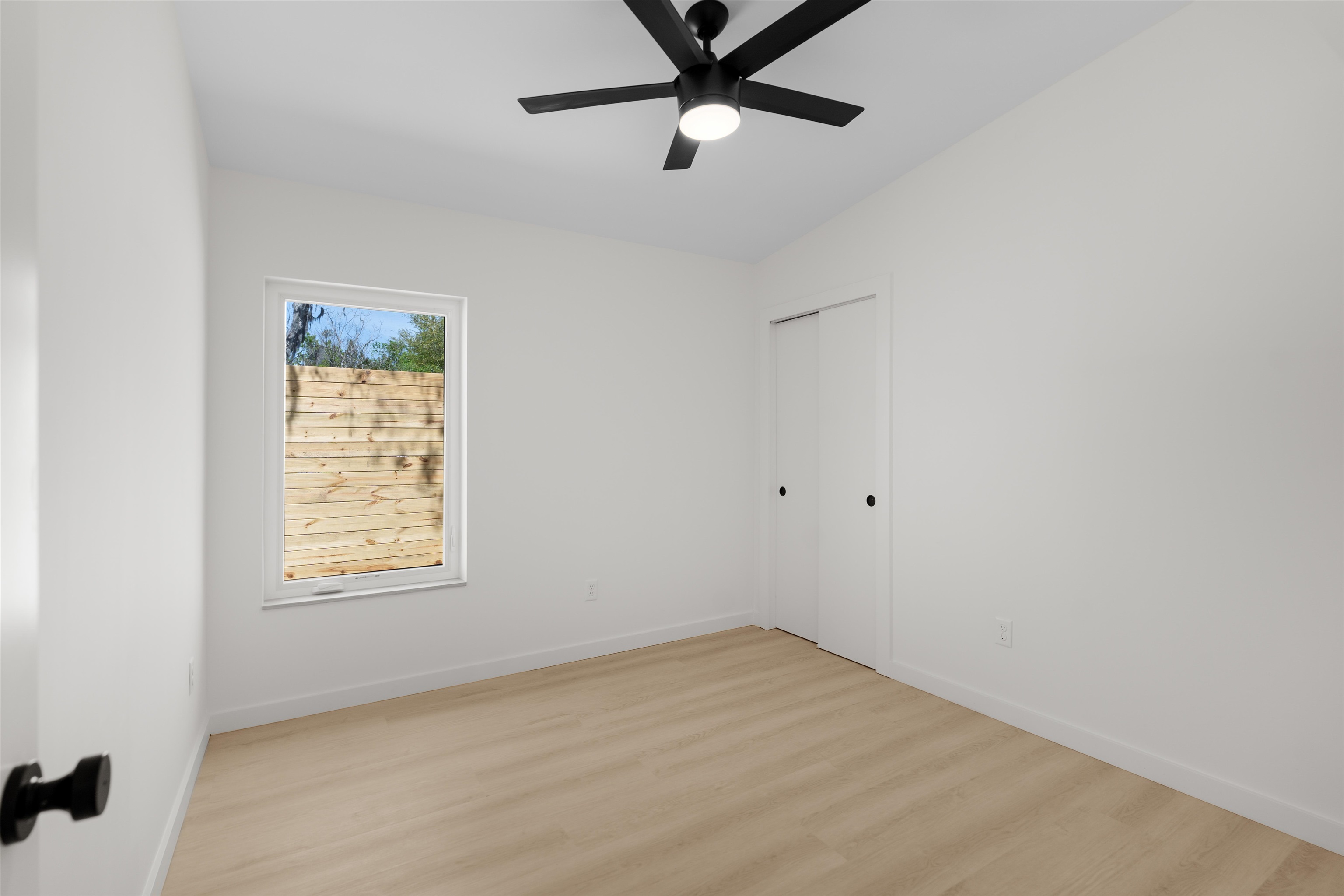 29 Masters Drive, Unit B St. Augustine, FL 32084 - Photo 16 of 28 an empty room with a window and a fan