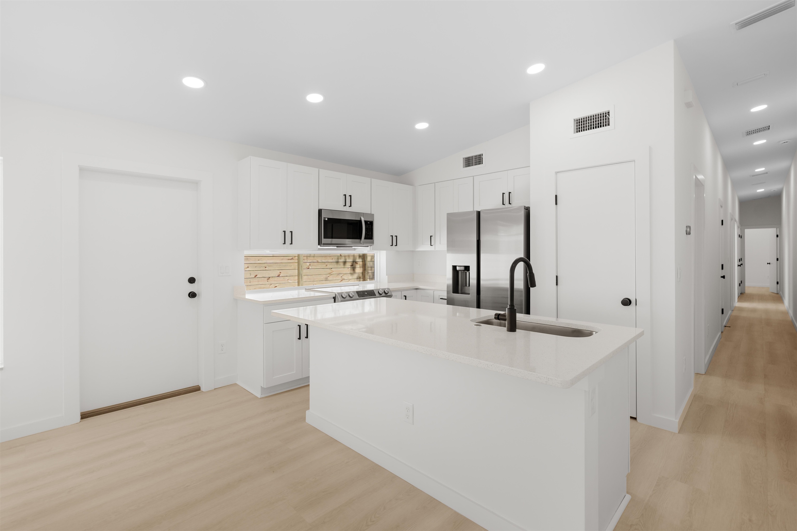 29 Masters Drive, Unit B St. Augustine, FL 32084 - Photo 3 of 28 a view of kitchen with sink refrigerator and microwave