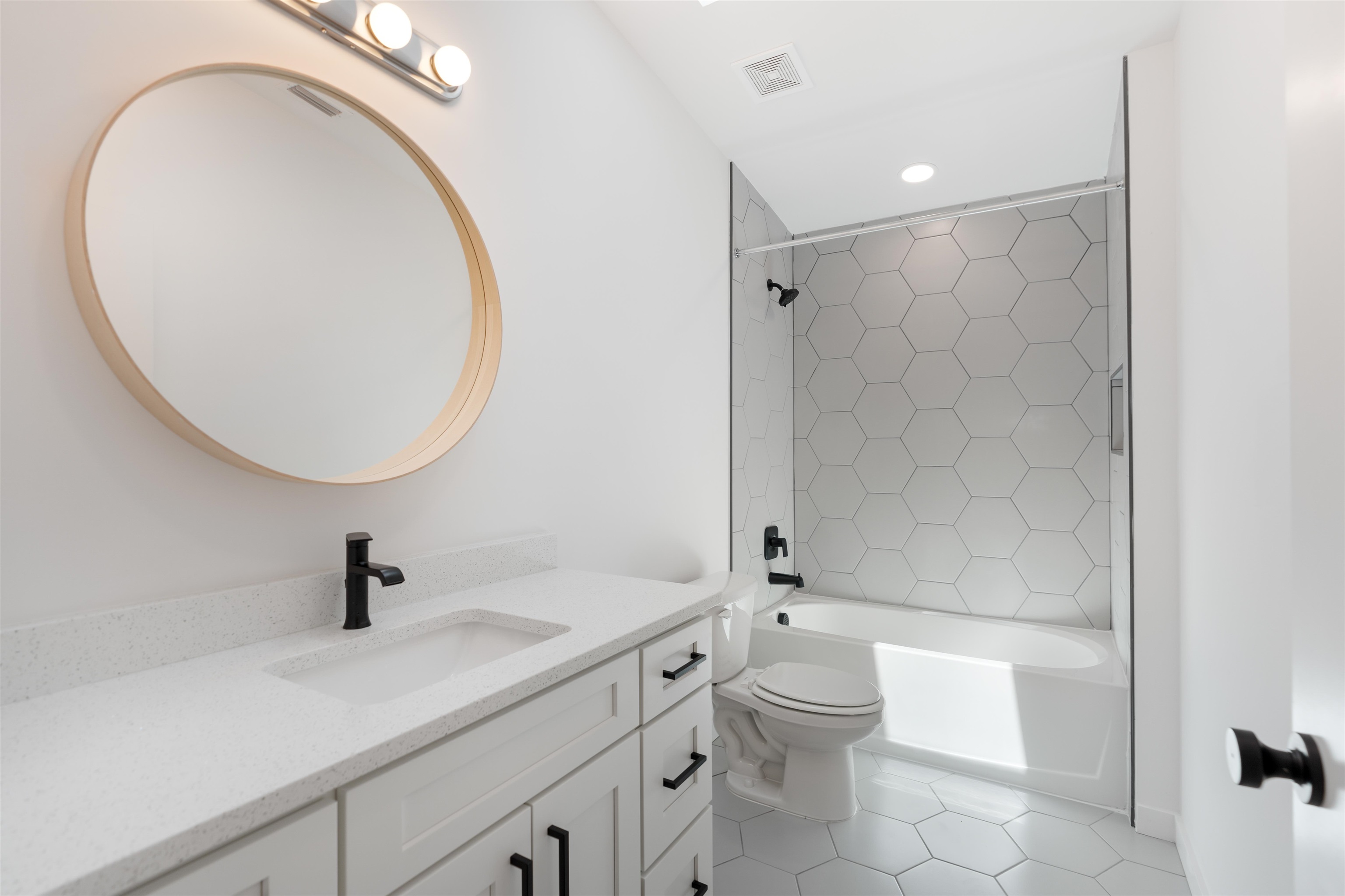 29 Masters Drive, Unit B St. Augustine, FL 32084 - Photo 9 of 28 a bathroom with a sink a toilet and a mirror