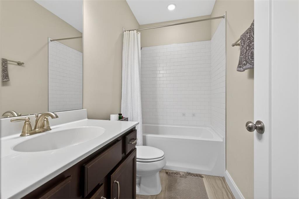 7012 Seneca Court Roswell, GA 30076 - Photo 23 of 65 a bathroom with a sink a toilet and shower