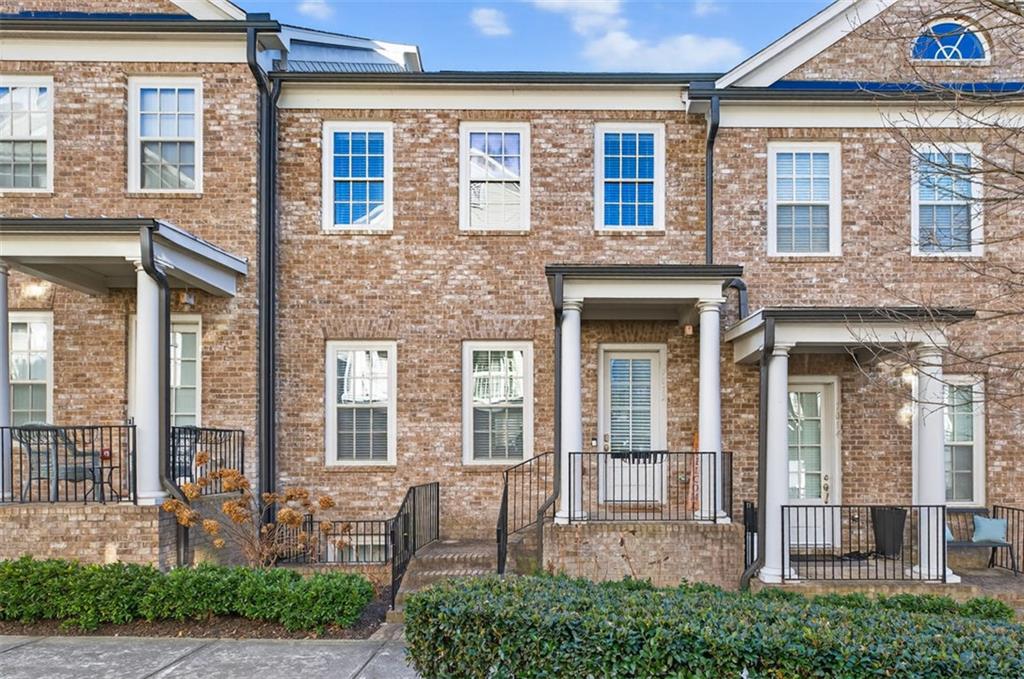 7012 Seneca Court Roswell, GA 30076 - Photo 3 of 65 front view of a brick house with a large windows