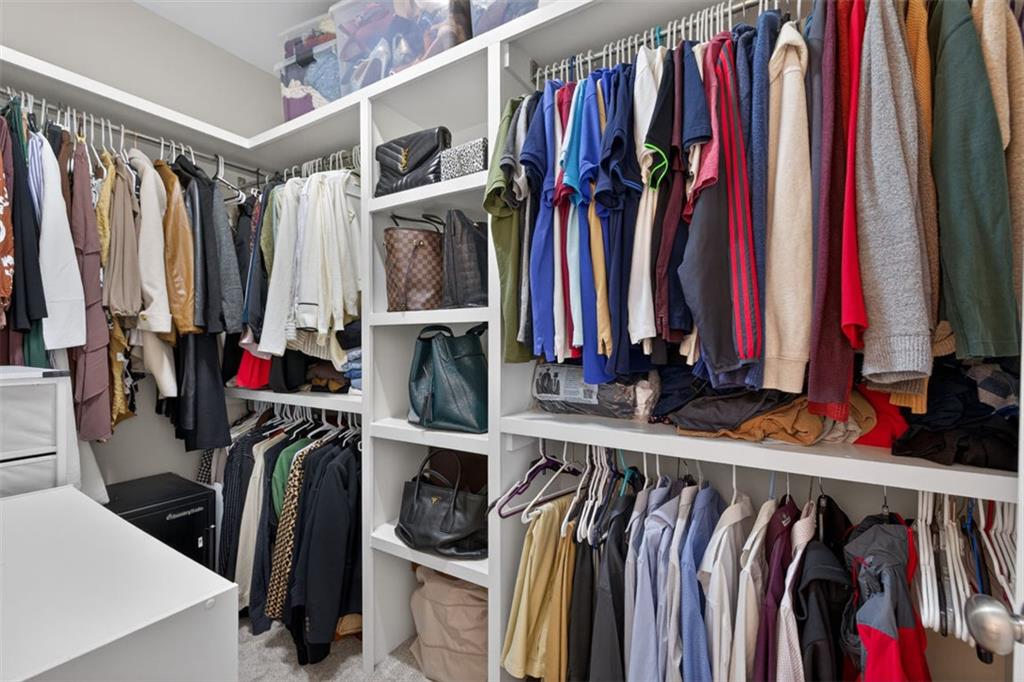 7012 Seneca Court Roswell, GA 30076 - Photo 33 of 65 a view of walk in closet with clothes