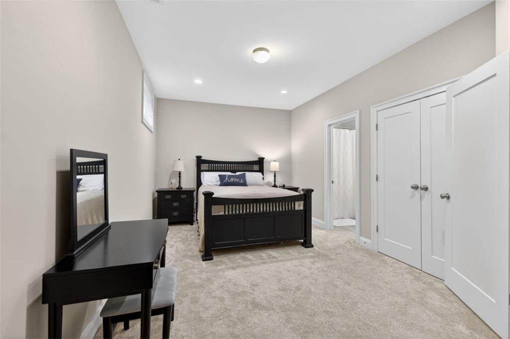 7012 Seneca Court Roswell, GA 30076 - Photo 49 of 65 a bedroom with a bed and a table in it