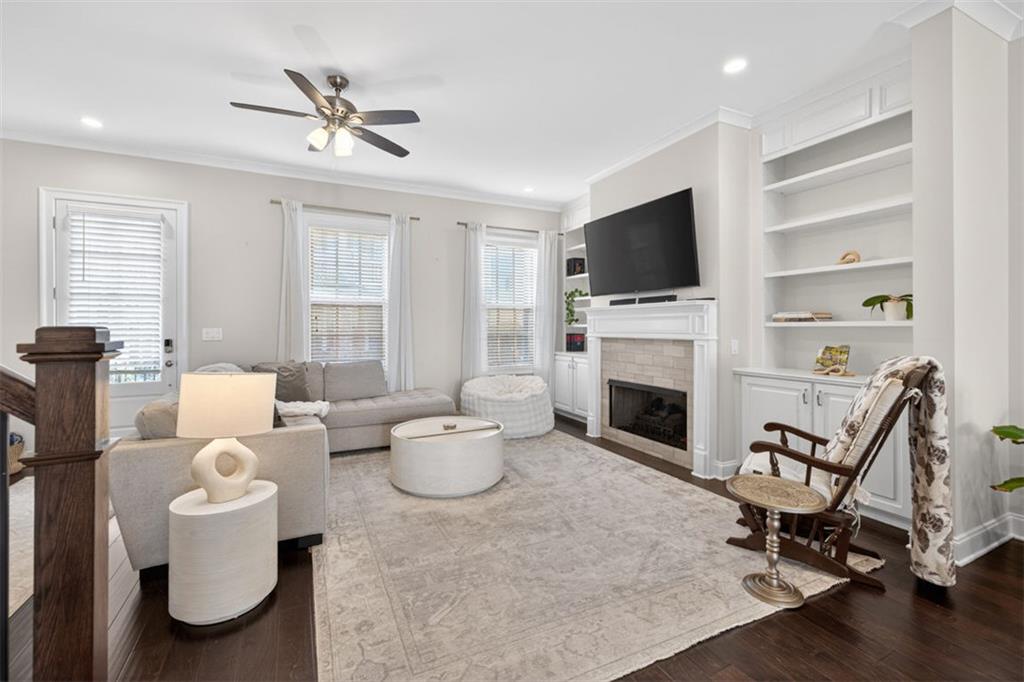 7012 Seneca Court Roswell, GA 30076 - Photo 6 of 65 a living room with furniture a fireplace and a flat screen tv