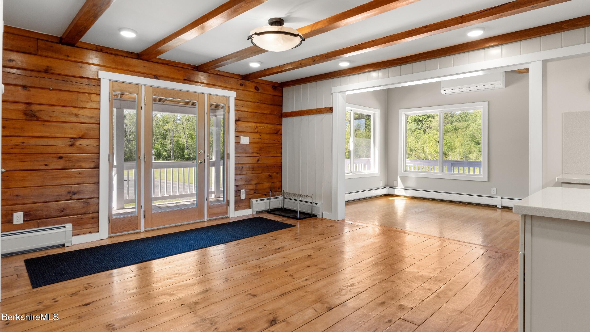 134 Hurlburt Road Great Barrington, MA 01230 - Photo 18 of 50 a view of an empty room with wooden floor and a window