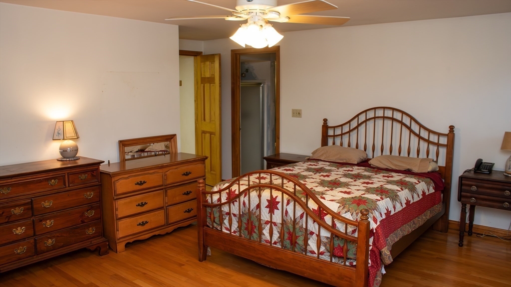 562 North Avenue Rochester, MA 02770 - Photo 14 of 32 a bedroom with a bed and a chandelier