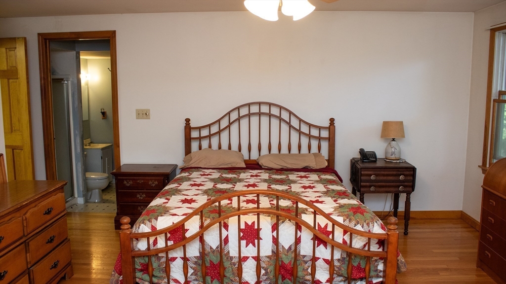 562 North Avenue Rochester, MA 02770 - Photo 15 of 32 a bedroom with a bed and wooden floor