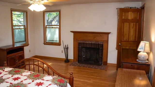 a bedroom with a bed and a fireplace