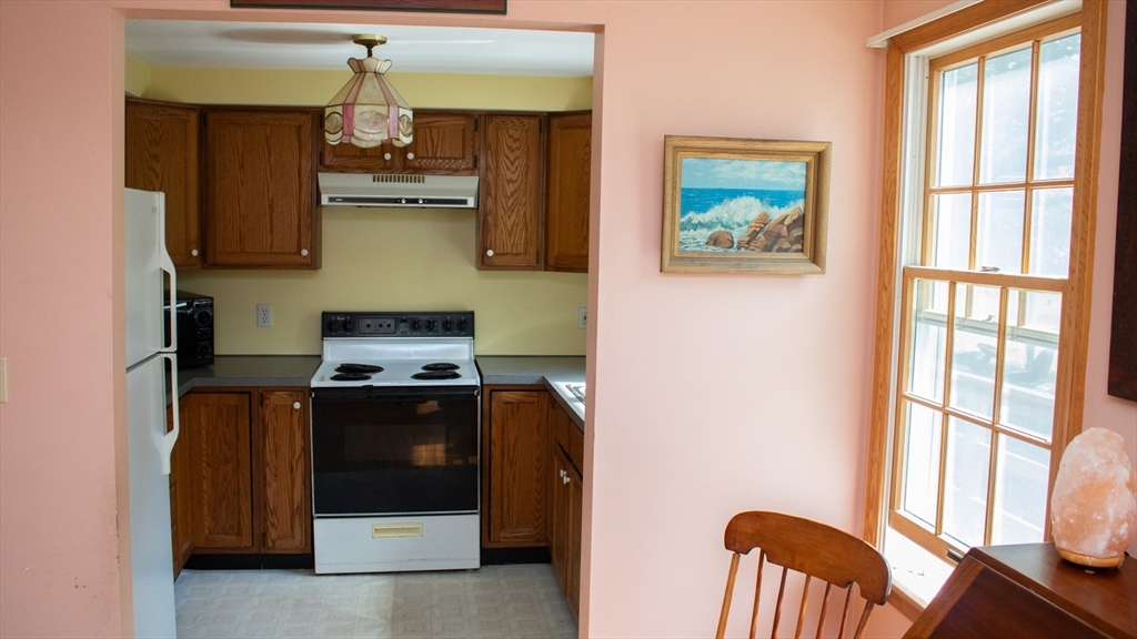 562 North Avenue Rochester, MA 02770 - Photo 28 of 32 a kitchen with stainless steel appliances granite countertop a stove a sink and a refrigerator