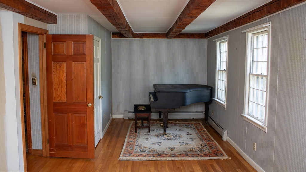 562 North Avenue Rochester, MA 02770 - Photo 5 of 32 a view of a hallway with wooden floor and a window