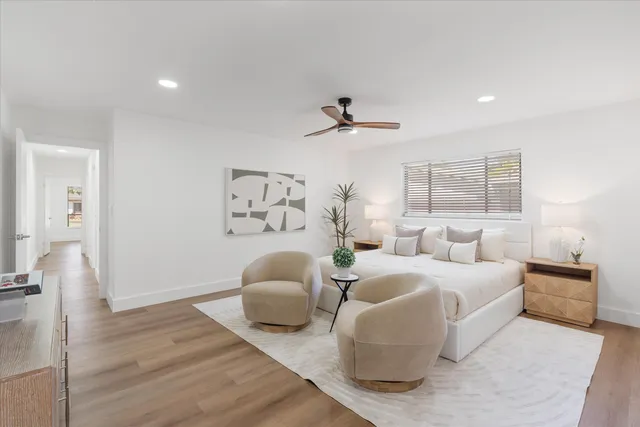 a bedroom with furniture and a large window