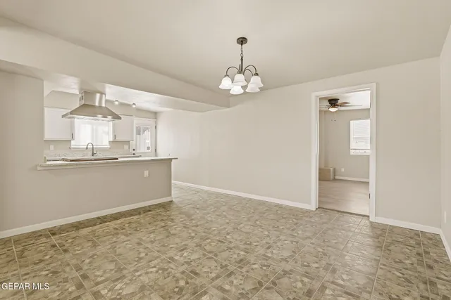 wooden floor in an empty room with a kitchen