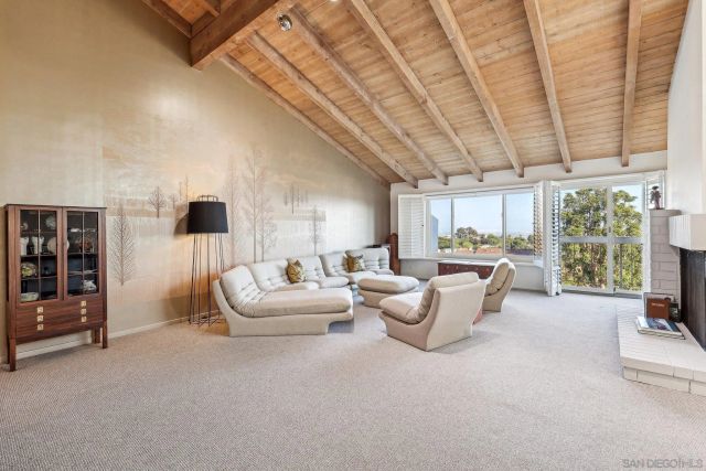 a living room with furniture and large windows