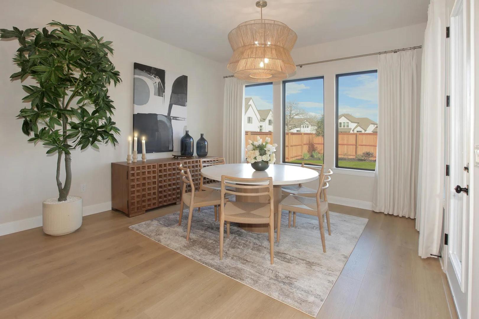 2033 Morning Mist Drive Georgetown, TX 78628 - Photo 20 of 36 a dining room with furniture potted plants and wooden floor