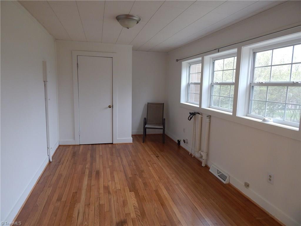 7830 Cherry Street Rural Hall, NC 27045 - Photo 15 of 21 Beautiful hardwood floors continue into the bonus room, lots of natural light. Water heater is inside this closet but it still leaves some room for storage items!!
