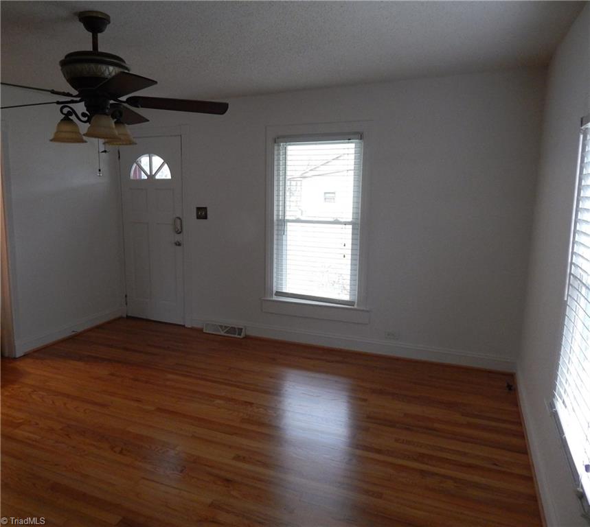 7830 Cherry Street Rural Hall, NC 27045 - Photo 3 of 21 Another view of the living room, beautiful ceiling fan and fresh paint!