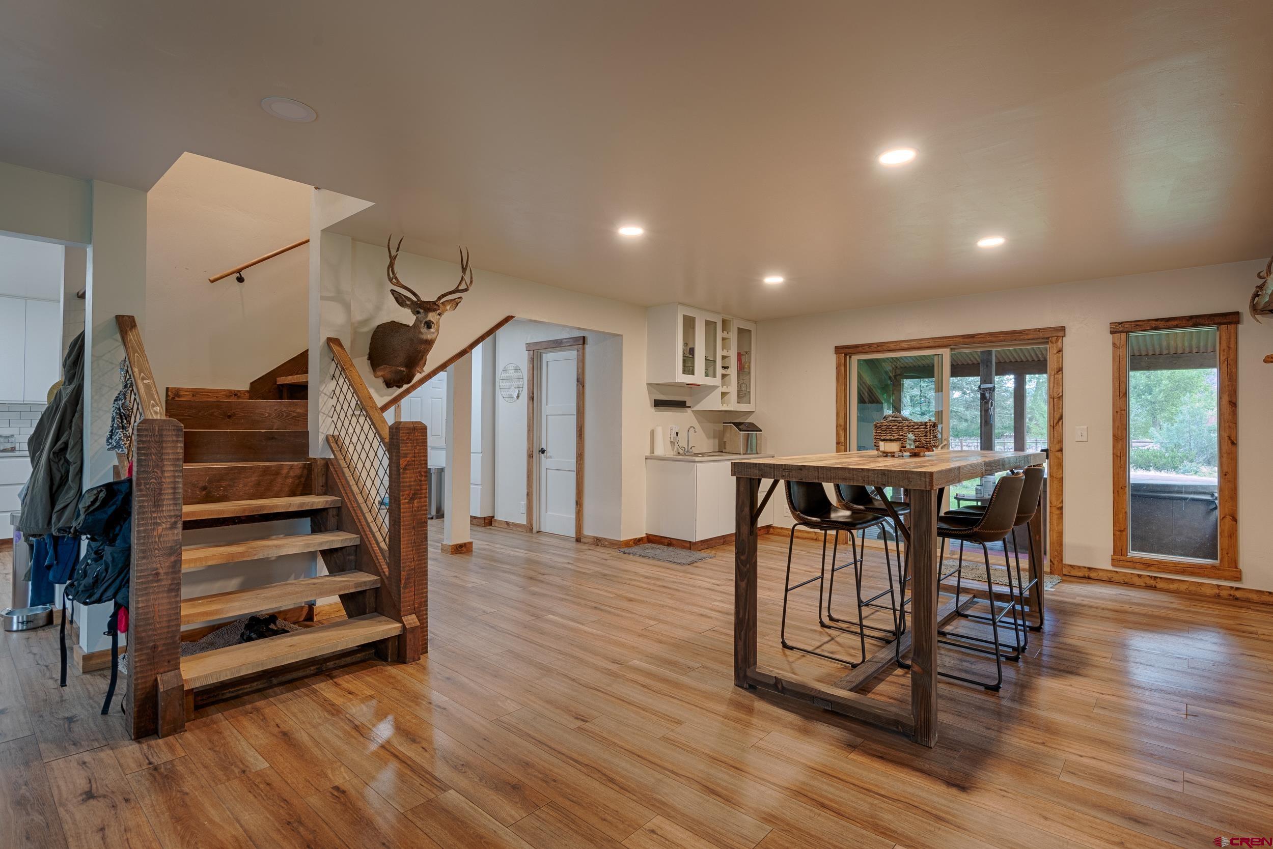559 Suzanne Lane Ridgway, CO 81432 - Photo 11 of 45 a view of a room with wooden floor stairs and windows