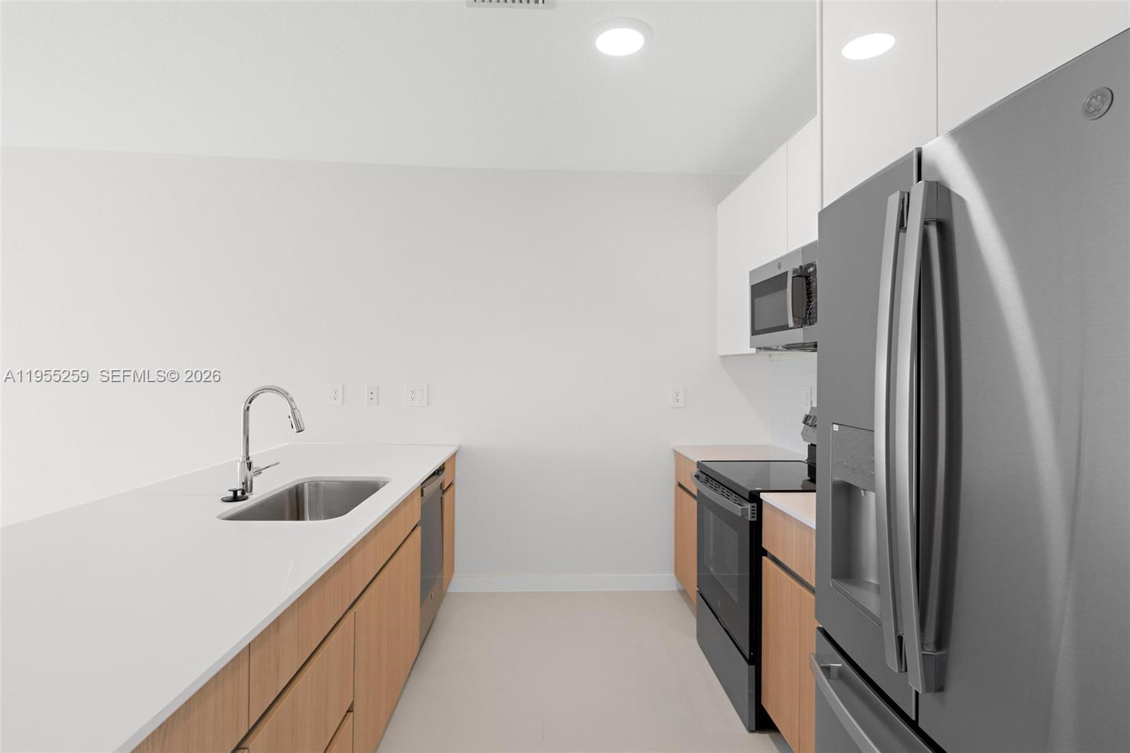 27319 Southwest 133rd Path Homestead, FL 33032 - Photo 14 of 32 a kitchen with stainless steel appliances granite countertop a refrigerator and a sink