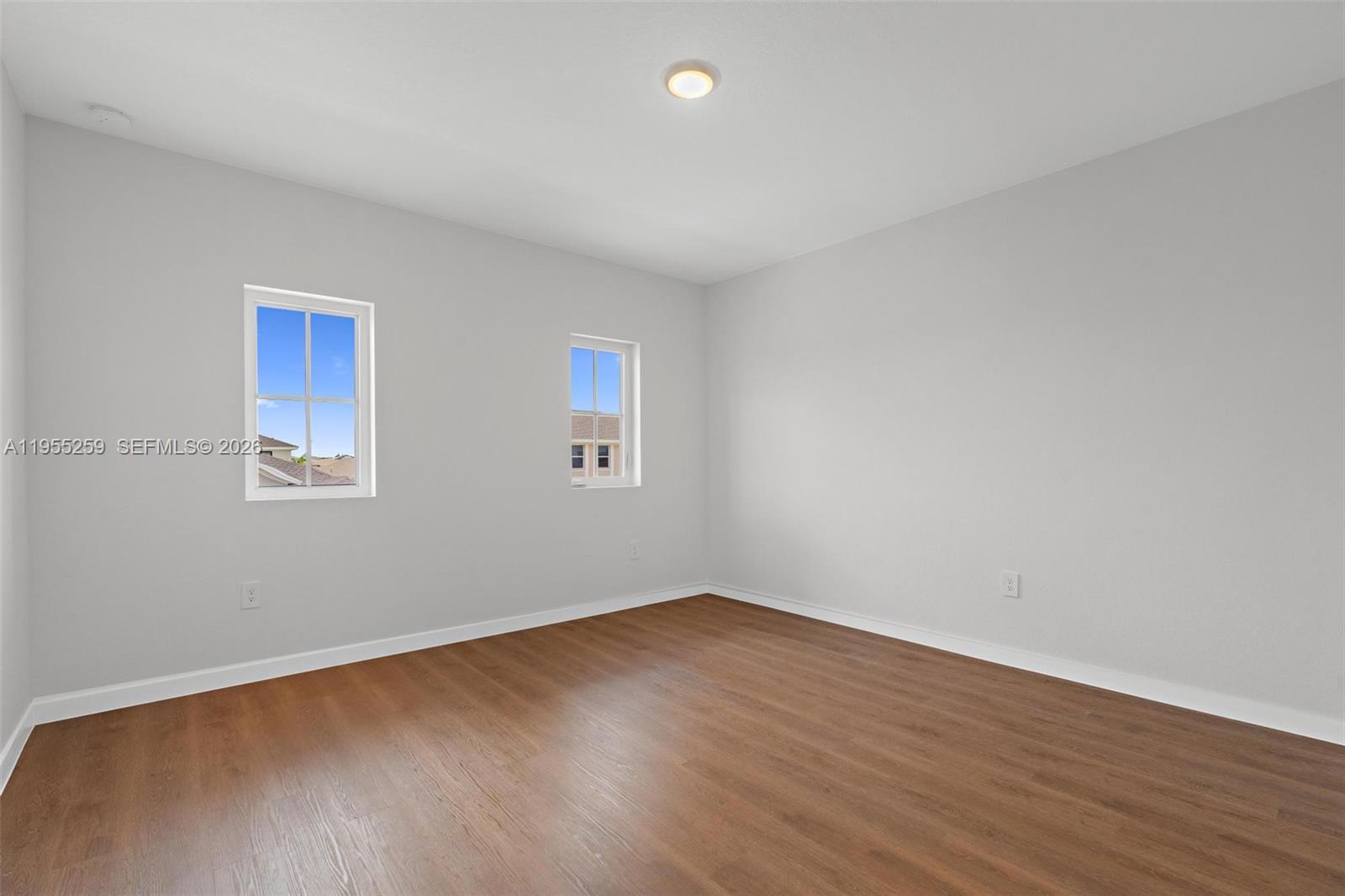27319 Southwest 133rd Path Homestead, FL 33032 - Photo 17 of 32 a view of a room with wooden floor and window