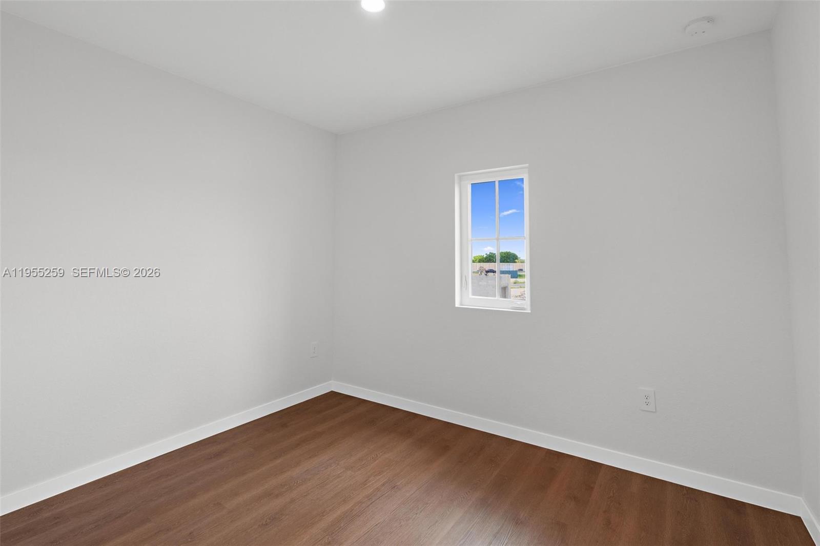 27319 Southwest 133rd Path Homestead, FL 33032 - Photo 22 of 32 a view of an empty room with wooden floor