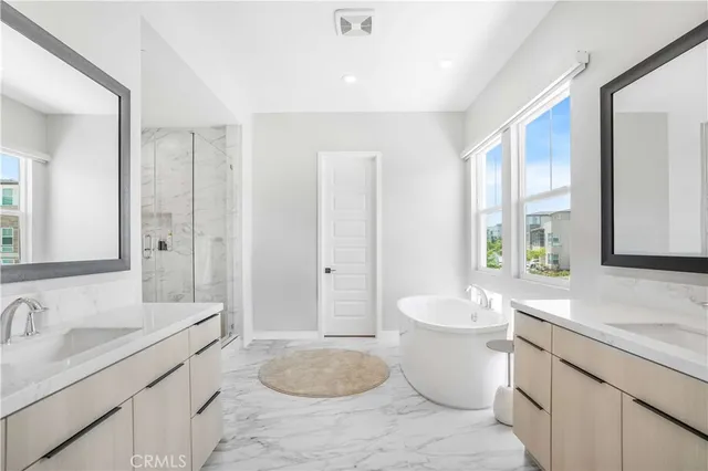 a spacious bathroom with a double vanity sink a mirror and a