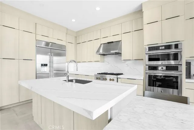a kitchen with stainless steel appliances a stove sink and cabinets