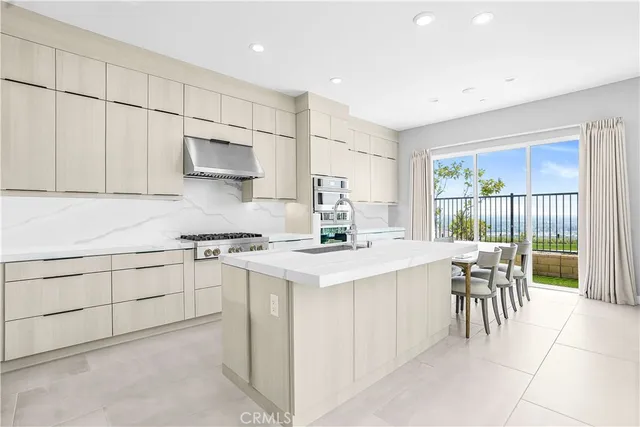 a kitchen with a stove a sink and a refrigerator