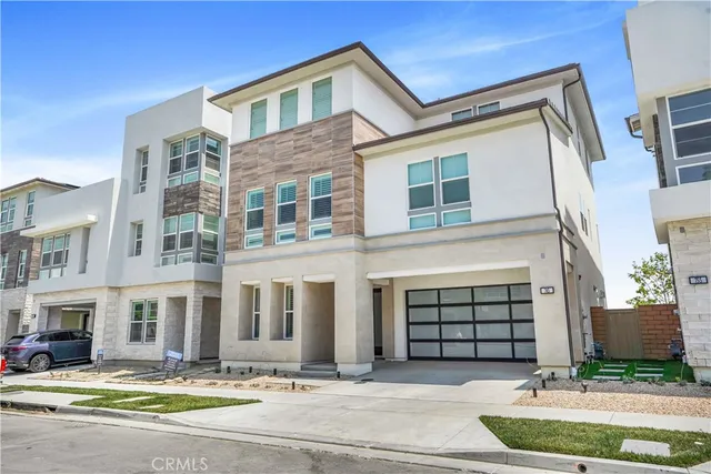 a front view of a house with a parking space