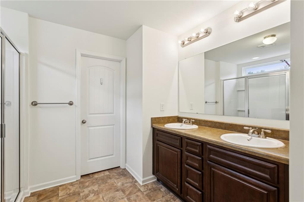 312 Upper Pheasant Court Ball Ground, GA 30107 - Photo 11 of 19 a bathroom with a sink and a mirror