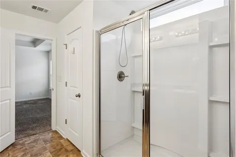 a bathroom with a glass shower door