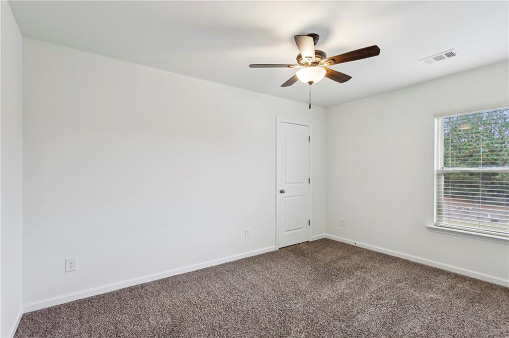 312 Upper Pheasant Court Ball Ground, GA 30107 - Photo 13 of 19 an empty room with a window and a fan