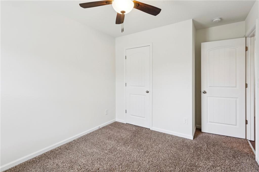312 Upper Pheasant Court Ball Ground, GA 30107 - Photo 14 of 19 an empty room with a ceiling fan
