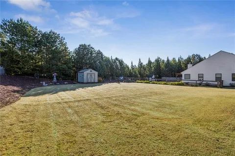 a house view with swimming pool in front of the house