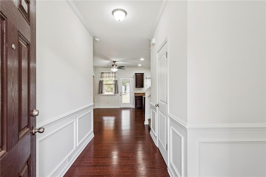 312 Upper Pheasant Court Ball Ground, GA 30107 - Photo 4 of 19 a view of a hallway with wooden floor and staircase
