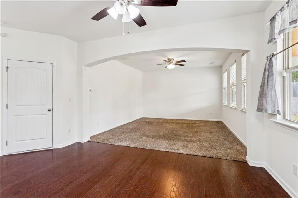 312 Upper Pheasant Court Ball Ground, GA 30107 - Photo 5 of 19 an empty room with wooden floor fan and windows