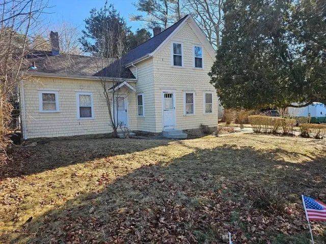a view of a house with a yard covered with snow