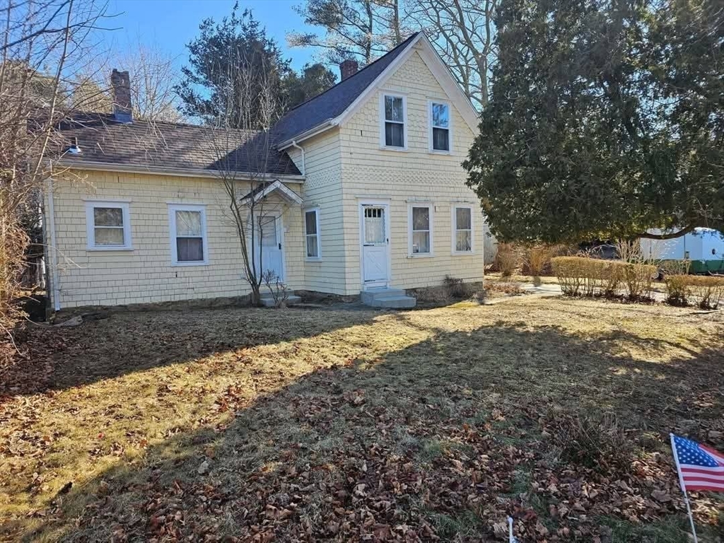 a view of a house with a yard covered with snow