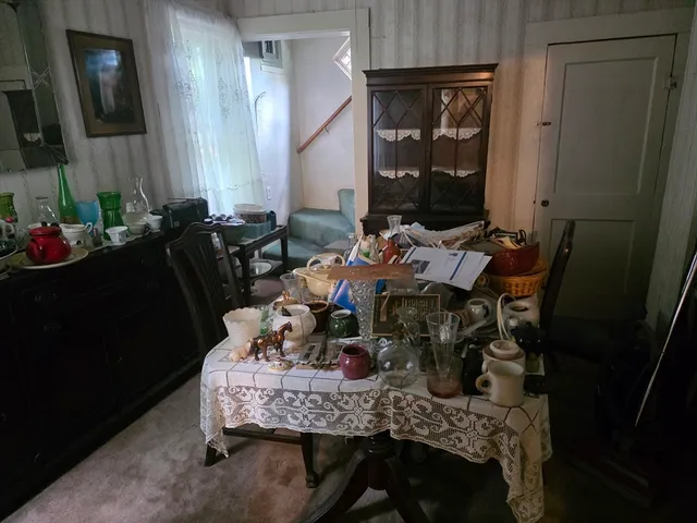 a dining room with furniture and wooden floor