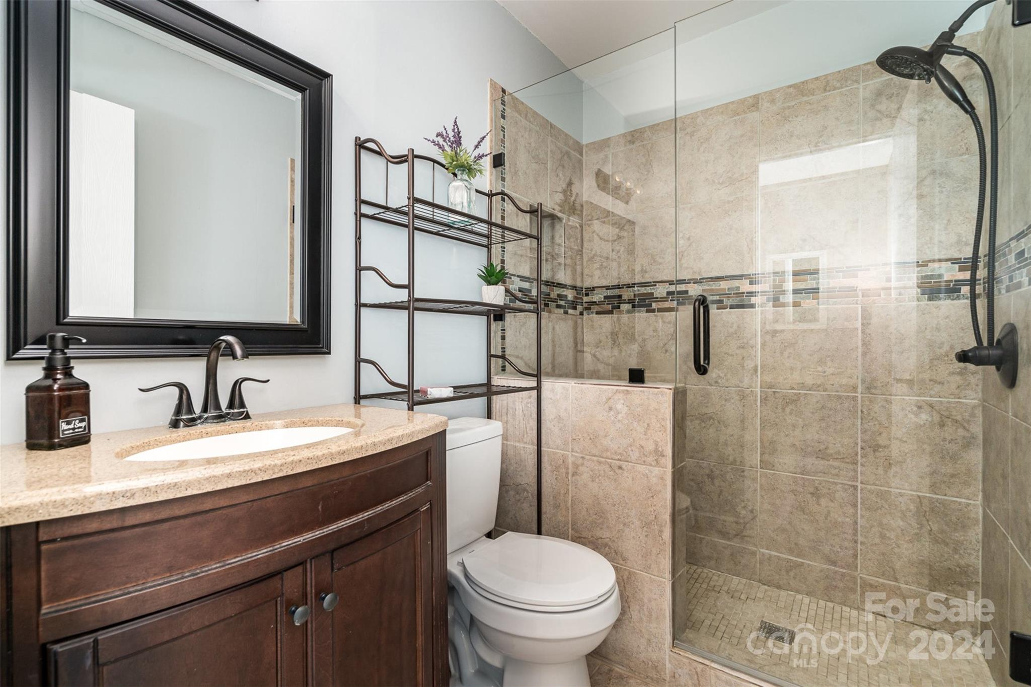 1316 Reid Harkey Road Matthews, NC 28105 - Photo 20 of 35 a bathroom with a granite countertop sink toilet and shower