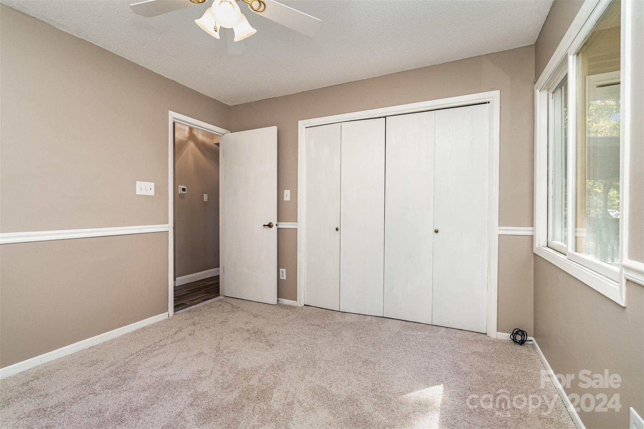 1316 Reid Harkey Road Matthews, NC 28105 - Photo 23 of 35 a view of a room with a ceiling fan and a window