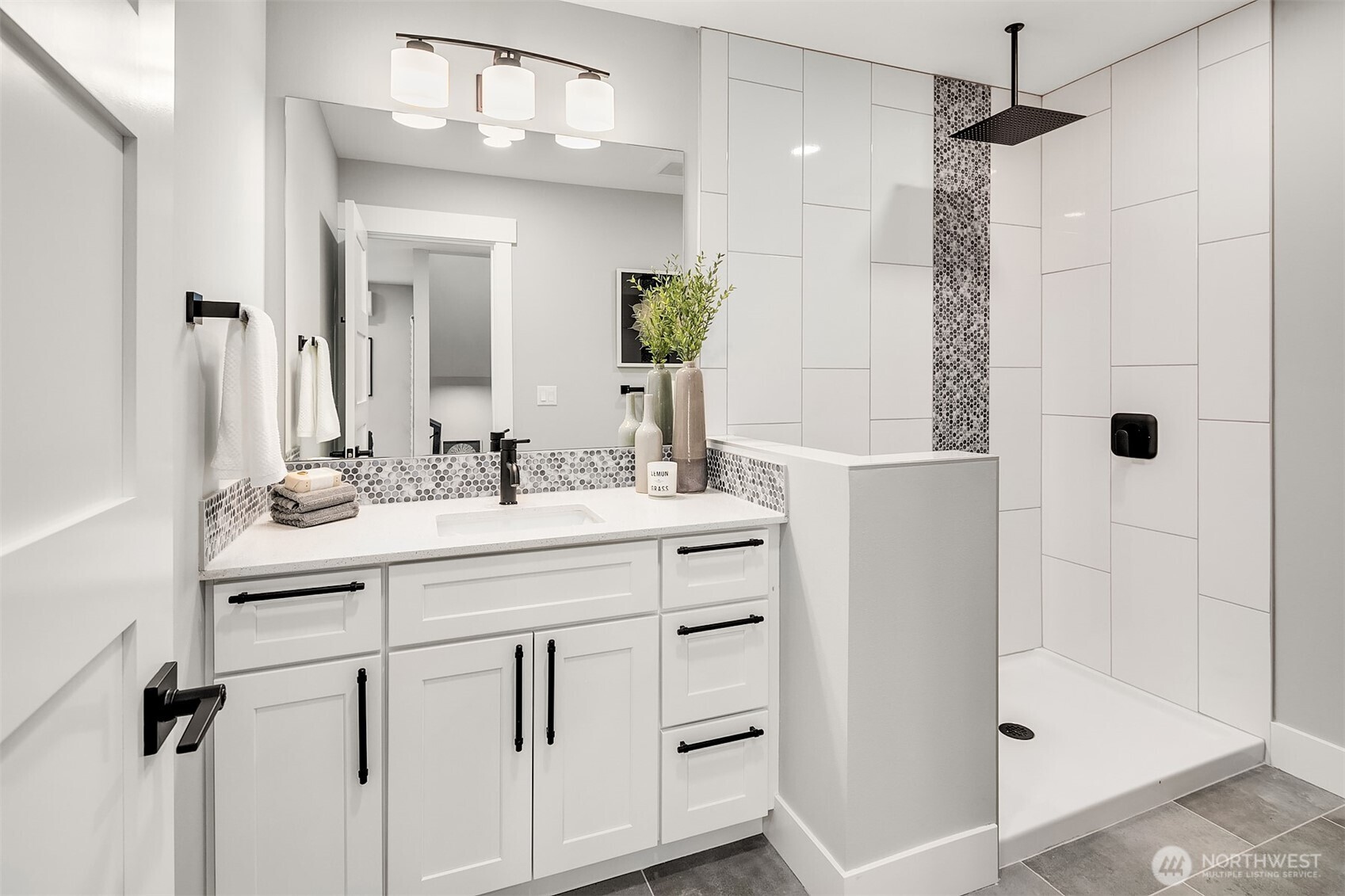 7528 215th Street Southwest, Unit 101 Edmonds, WA 98026 - Photo 12 of 29 a bathroom with a shower sink and mirror