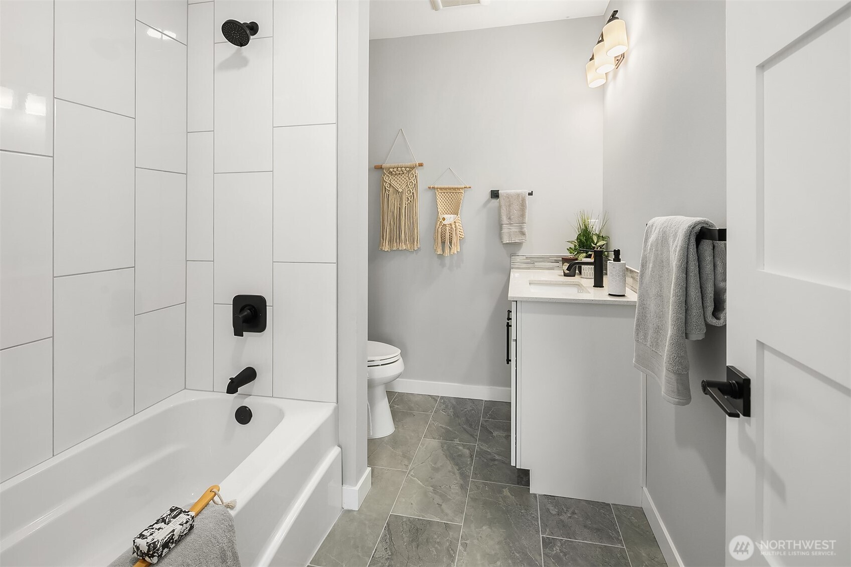 7528 215th Street Southwest, Unit 101 Edmonds, WA 98026 - Photo 16 of 29 a bathroom with a bathtub a toilet and a shower